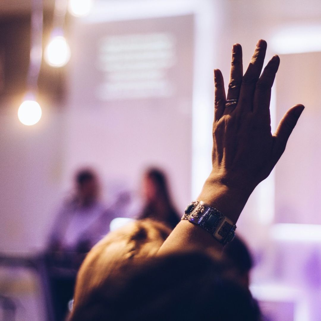 Person in audience with hand up